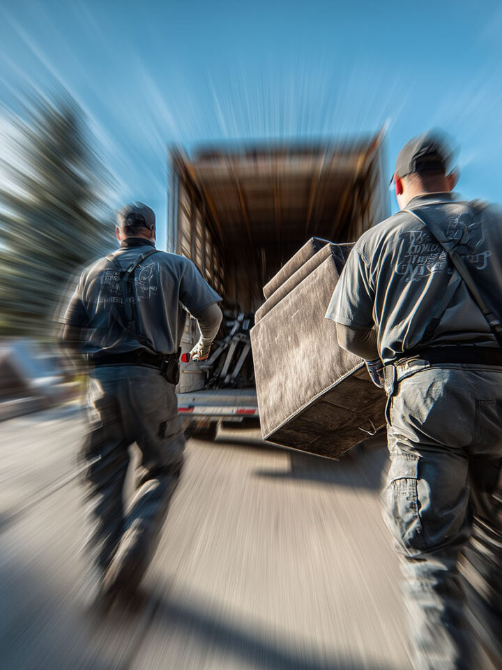 The Trash Bandits team performing a same day junk removal shreveport, quickly loading furniture onto their truck.
