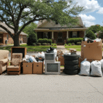 A variety of household junk—furniture, electronics, tires, and bagged waste—lines a Shreveport street, ready for pickup.
